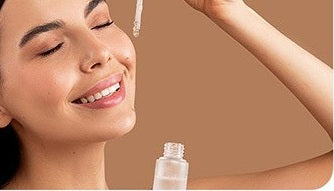 A dropper applying a clear serum beside the eye