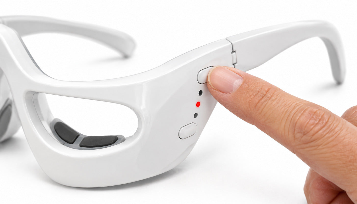 A finger pressing the power and mode button beside the hinge of the white frame