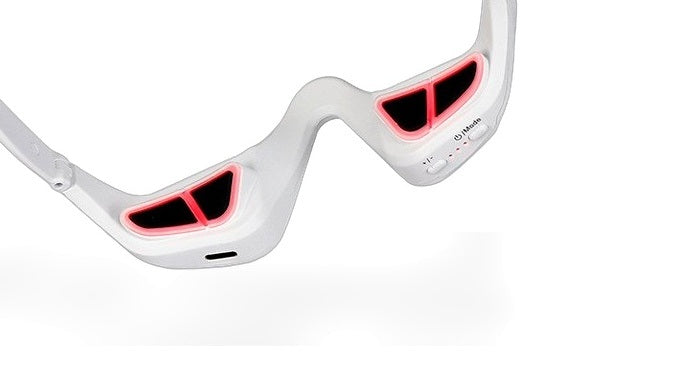 The eye massage glasses on a plain white background with the four contact pads lit red