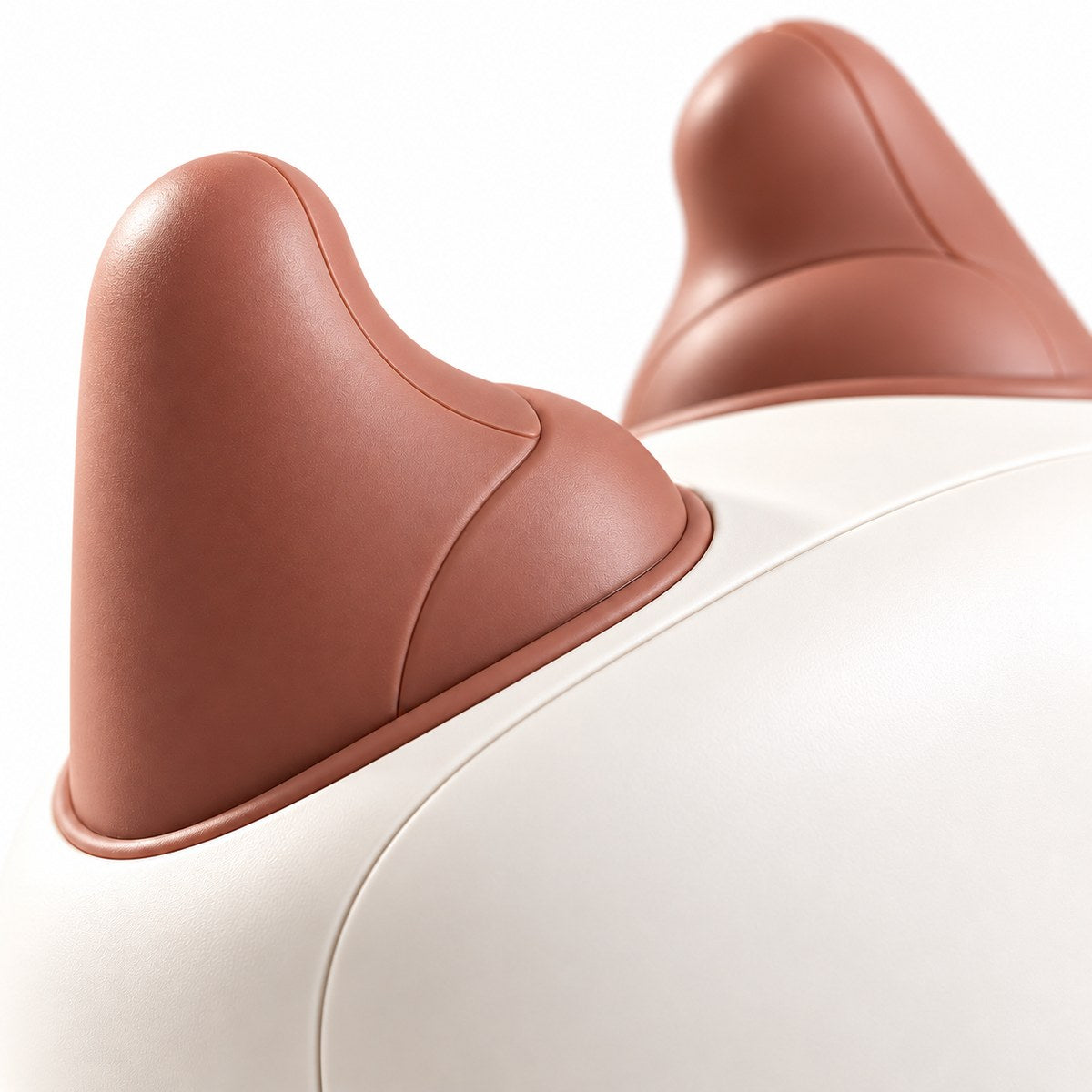 Close-up of two soft silicone massage pads on the white housing